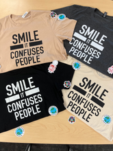 Load image into Gallery viewer, &quot;SMILE IT CONFUSES PEOPLE&quot; T-Shirt - Sand
