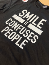 Load image into Gallery viewer, &quot;SMILE IT CONFUSES PEOPLE&quot; T-Shirt - Black
