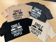 Load image into Gallery viewer, &quot;SMILE IT CONFUSES PEOPLE&quot; T-Shirt - Cream
